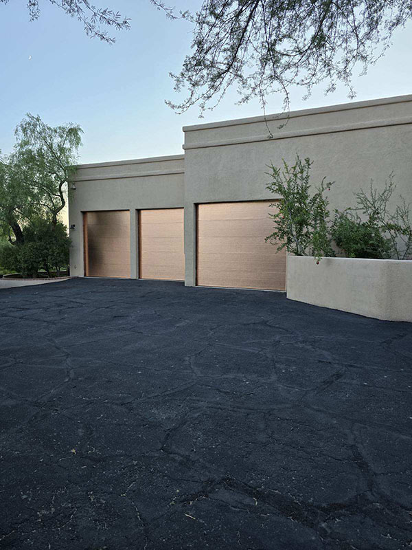 Technician repairing a garage door in Tucson, AZ